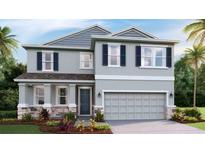 Modern two-story house with gray siding, stone accents, and landscaping at 708 160Th E Ln, Bradenton, FL 34212