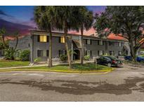 Gray condo building with parking and landscaping at dusk at 3822 Cortez Dr # D, Tampa, FL 33614