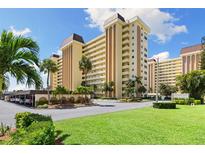 Attractive multi-story condo building featuring multiple balconies, manicured landscaping, and convenient covered parking at 4550 Cove Cir # 501, St Petersburg, FL 33708