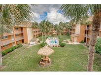Community courtyard featuring a pool and picnic area at 12760 Indian Rocks Rd # 510, Largo, FL 33774