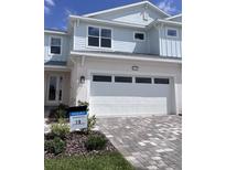 Charming two-story home featuring a two-car garage and landscaped front yard at 31907 Anchor Point Dr, Wesley Chapel, FL 33545