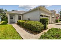 Single story home with two-car garage and manicured hedges at 6919 Surrey Hill Pl, Apollo Beach, FL 33572