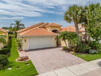 Single-Gathering home with brick driveway, lush landscaping and two-car garage at 4943 Sandy Brook Cir, Wimauma, FL 33598