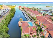 Stunning aerial view showcasing the waterfront condos, boat docks, and beautiful community pool at 5000 Culbreath Key Way # 4-306, Tampa, FL 33611