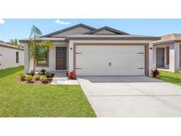 New construction home with two-car garage and landscaped yard at 13064 Meadow Swallow Ave, Weeki Wachee, FL 34614