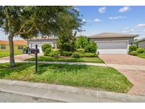 Two-car garage home with nicely landscaped yard at 15626 Aurora Lake Cir, Wimauma, FL 33598