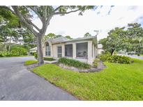 Charming home featuring a screened-in porch and well-maintained landscaping with mature trees at 1224 Golfview Woods Dr, Sun City Center, FL 33573