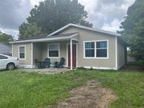 House exterior featuring a neutral color palette and front yard at 9463 Arbol Ct, Largo, FL 33773