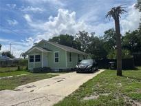 Light green house with a driveway and a palm tree at 1161 Kingsley St, Clearwater, FL 33756