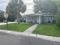 One-story house with a covered porch and a well-maintained lawn at 120 S San Remo Ave, Clearwater, FL 33755