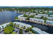 Aerial view of waterfront community with boat slips and lush landscaping at 5144 Salmon Se Dr # A, St Petersburg, FL 33705