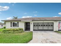 Exterior of a condo with a carport and American flag at 2507 Lancaster Dr, Sun City Center, FL 33573