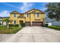 Two-story house with double garage at 10820 Carloway Hills Drive, Wimauma, FL 33598