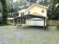 Two-story house with carport and landscaped yard at 315 Wooten Rd, Lutz, FL 33548