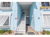 Exterior view of light blue building with white stairs at 3730 42Nd S Way # G, St Petersburg, FL 33711