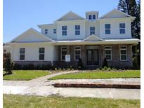 Elegant two-story home with brick accents, a manicured lawn, and charming curb appeal at 4536 W Swann Ave, Tampa, FL 33629