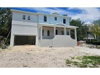 Newly constructed two-story home featuring white brick and siding under a cloudy blue sky at 610 Ontario Ave, Tampa, FL 33606