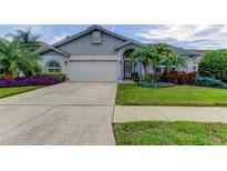 Two-story house with two car garage and lush landscaping at 11426 Glenmont Dr, Tampa, FL 33635