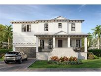 Two-story home with white siding, gray accents, and a brick base at 610 Ontario Ave, Tampa, FL 33606