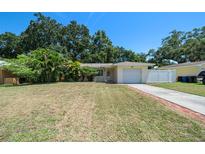 House exterior with a driveway and grassy lawn at 2452 Chaucer St, Clearwater, FL 33765