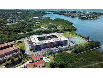 Aerial view of waterfront community with tennis court and pool at 12760 Indian Rocks Rd # 1004, Largo, FL 33774