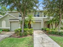 Two-story townhome with a 2-car garage and landscaped front yard at 2748 Birchcreek Dr, Wesley Chapel, FL 33544