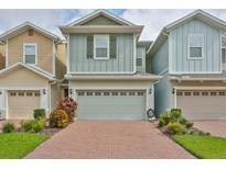 Modern townhome with two-car garage and brick driveway at 6378 Camino Dr, Apollo Beach, FL 33572