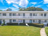 Exterior view of condo building with manicured lawn at 8320 112Th St # 104, Seminole, FL 33772