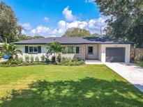Newly renovated home with a landscaped lawn and modern finishes at 1227 Arden Ave, Clearwater, FL 33755