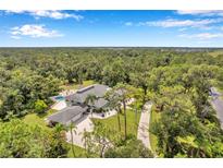 Aerial view of house with pool and large lot at 6775 Timberland Ln, Sarasota, FL 34241