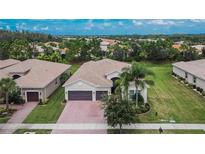 Single-Gathering home with two-car garage and lush landscaping at 16005 Cape Coral Dr, Wimauma, FL 33598