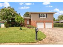 Brick home with two-car garage and nicely landscaped yard at 8212 Forest Cir, Seminole, FL 33776
