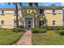 Building exterior showing landscaped grounds and walkway at 105 Pompano Se Dr # A, St Petersburg, FL 33705