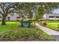 Building exterior with landscaping and walkway at 36750 Us Highway 19 N # 05102, Palm Harbor, FL 34684