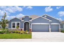 Charming single-Gathering home with a three-car garage, stone accents and well-maintained landscaping at 16044 7Th E Ave, Bradenton, FL 34212