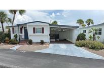 Charming single-story home with a covered patio, featuring well-maintained landscaping and a concrete driveway at 4851 W Gandy Blvd # B11L35, Tampa, FL 33611