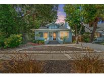 Charming bungalow with light blue siding, mature landscaping, and a welcoming front porch at 2111 Burlington N Ave, St Petersburg, FL 33713