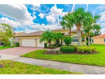 Attractive single-Gathering home with a three-car garage and lush landscaping at 4963 Sapphire Sound Dr, Wimauma, FL 33598