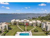 Condo building with waterfront view and community pool at 50 Coe Rd # 224, Belleair, FL 33756
