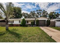 Ranch-style home with a well-maintained lawn and driveway at 2048 64Th S Ave, St Petersburg, FL 33712