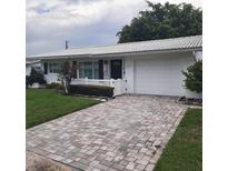 House exterior featuring a brick driveway and white front door at 10011 40Th N St # 3, Pinellas Park, FL 33782