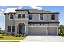 Beautiful two-story home with a three-car garage and well-maintained landscaping at 3437 Yellow Leaf Cir, Spring Hill, FL 34609