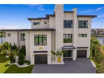 A modern, waterfront home with a three-car garage at 490 Laguna Dr, Tierra Verde, FL 33715