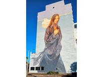 Large building with a captivating mural depicting a Personal at 226 5Th N Ave # 1101, St Petersburg, FL 33701