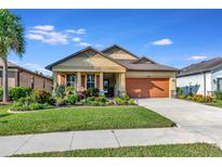 One-story house with orange garage door and landscaped yard at 6342 Kenava Loop, Palmetto, FL 34221