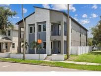 Modern two-story house with gray siding and a white fence at 2138 - 2 W Beach St, Tampa, FL 33607
