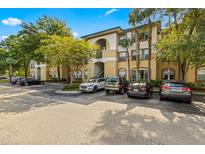 Condo building exterior with parking and landscaping at 17104 Carrington Park Dr # 520, Tampa, FL 33647