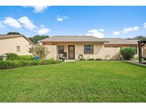 Cute yellow house with a well-maintained lawn and landscaping at 38401 Cottonwood Pl # 38401, Zephyrhills, FL 33542