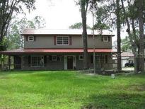 Two story home with large yard and red roof at 8945 Overlook Dr, Wesley Chapel, FL 33545