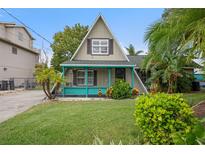 A-frame home with teal accents and landscaped yard at 4530 Flounder Dr, Hernando Beach, FL 34607
